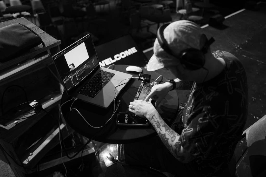 Gavin Strange on stage, setting up his gear.