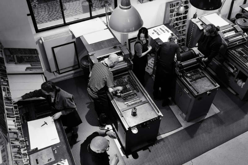 A photo from above onto attendees of a letter press workshop at p98a