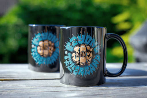 photos shows mugs that are printed with the design Mark Caneso crafted
