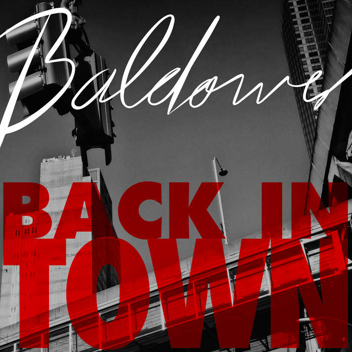 Cover of the album “Back in Town” by Baldower. You see the artist name “Baldower” on top and the album name “Back in Town” in red at the bottom. Both written over a city scene with traffic lights and buildings.