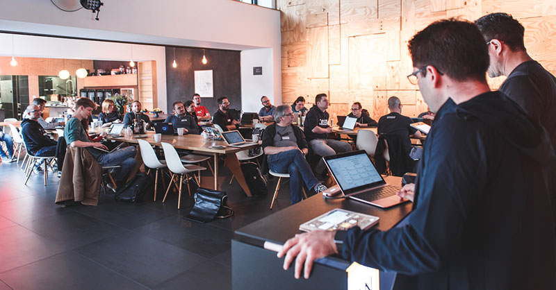 A photo showing the opening session at the Indie Web Camp in Düsseldorf with speakers and attendees.
