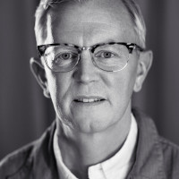 A portrait photo of Aarron Walter who looks straight into the camera, gently smiling