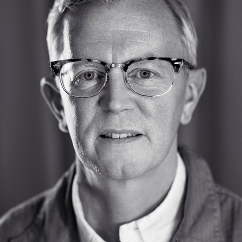 A portrait photo of Aarron Walter who looks straight into the camera, gently smiling