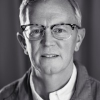 A portrait photo of Aarron Walter who looks straight into the camera, gently smiling