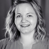A portrait shot of Stephanie Eckles. She is smiling into the camera with a straight look into the camera.