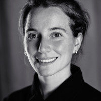 A portrait shot of Katie Menzies. She smiles and looks into the camera