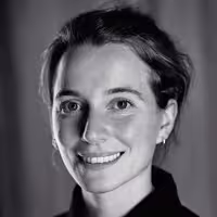 A portrait shot of Katie Menzies. She smiles and looks into the camera