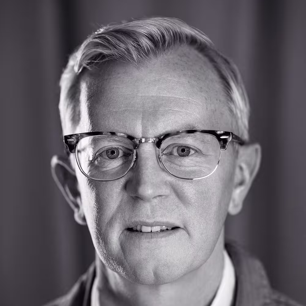 A portrait photo of Aarron Walter who looks straight into the camera, gently smiling